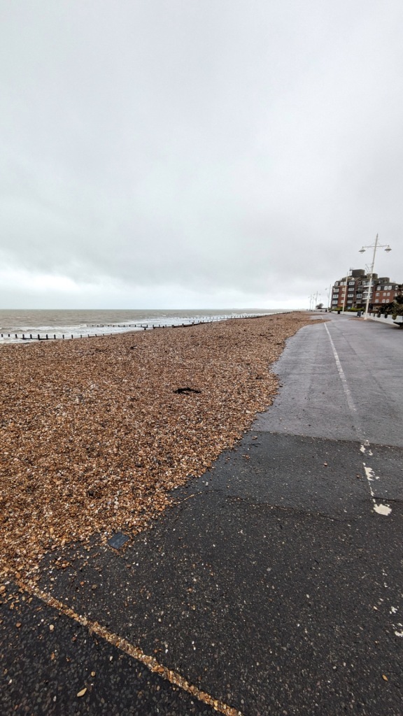 The promenade at Bognor Regis scattered with stones from the beach