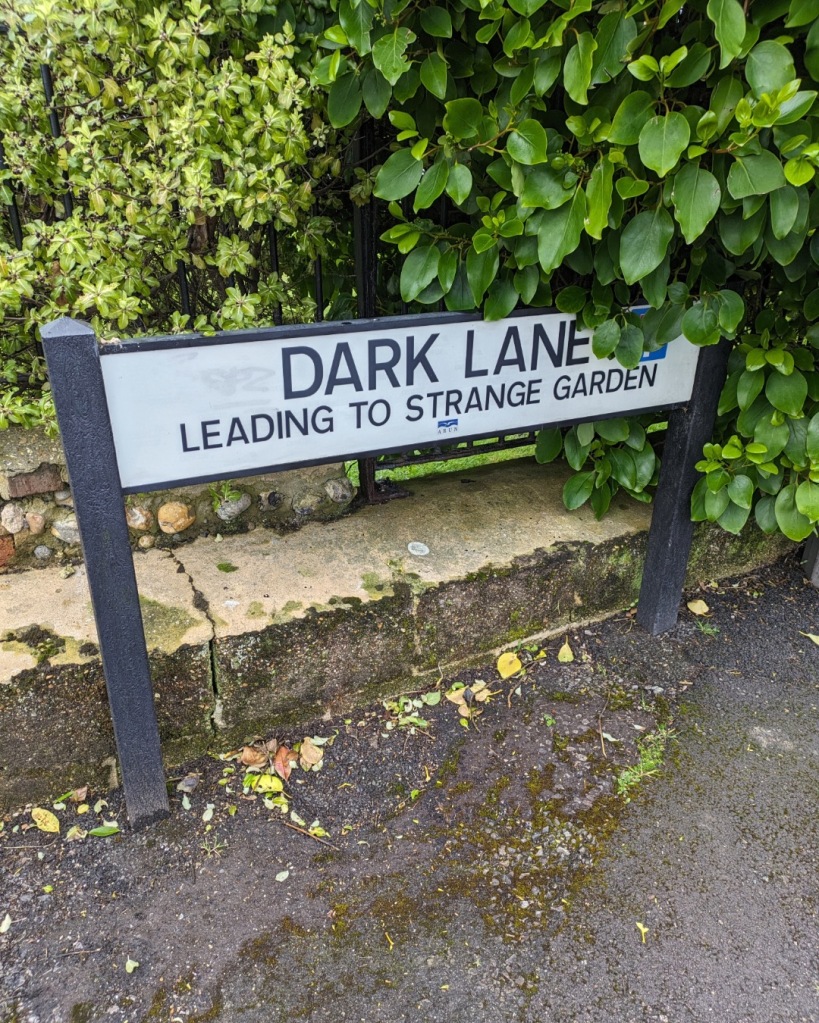 A street sign for Dark Lane, leading to Strange Graden