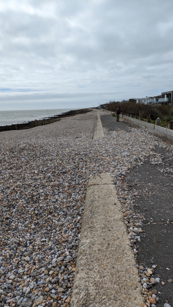 The promenade at Selsey covered in places with piles of stones